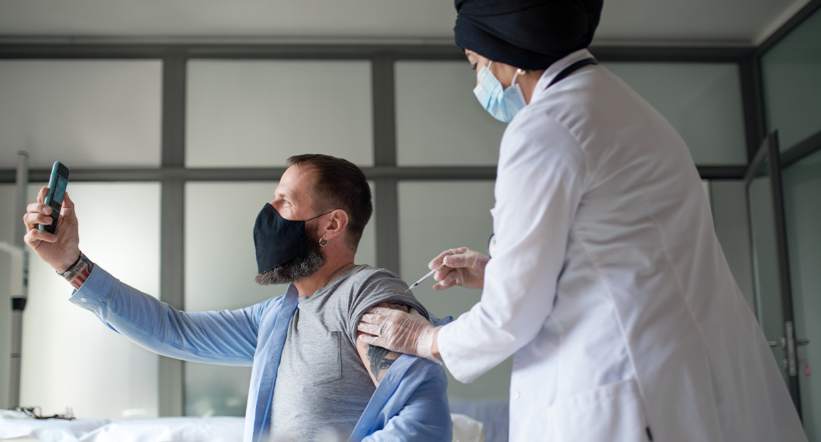 Man taking selfie during medical exam.