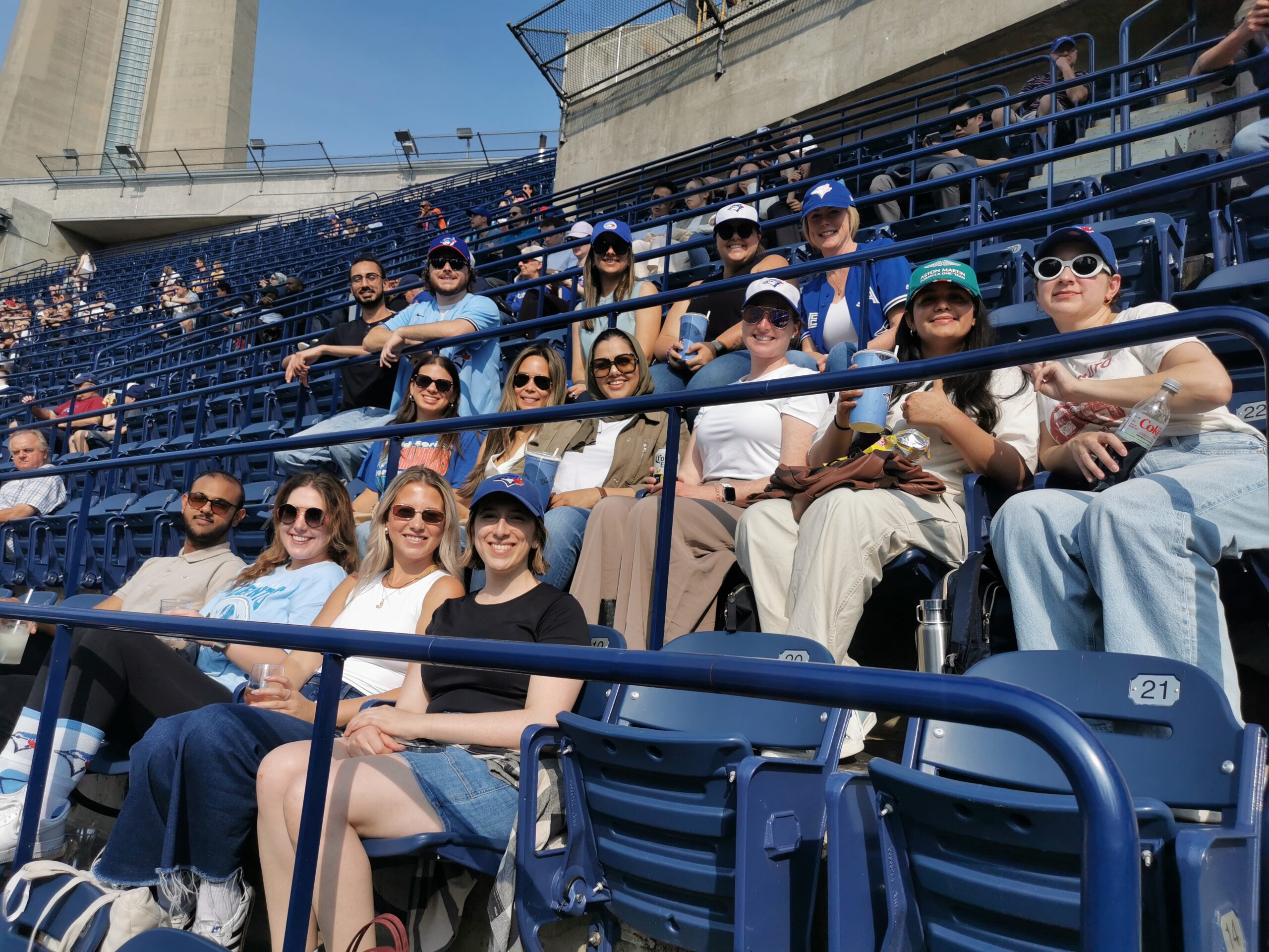 GCI Health Team in Canada sitting at a baseball game in the warm sun.