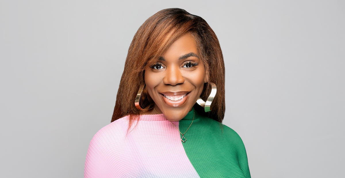Headshot of women with pink and green sweater